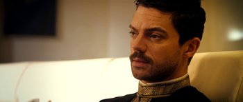 Movie still from “The Devil's Double” (2011), directed by Lee Tamahori – A person with a mustache wearing a uniform; Close Up shot, Over the shoulder angle