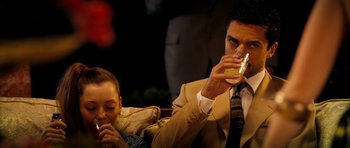 Movie still from “The Devil's Double” (2011), directed by Lee Tamahori – A man and a woman are drinking champagne; Medium shot, Over the shoulder angle