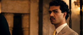 Movie still from “The Devil's Double” (2011), directed by Lee Tamahori – A person with a mustache wearing a tie; Close Up shot, Over the shoulder angle