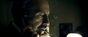 Movie still from “The Devil's Double” (2011), directed by Lee Tamahori – A person smoking a cigarette; Close Up shot, Low angle