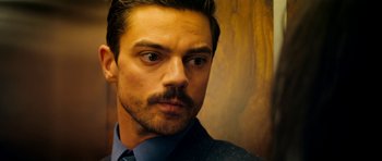 Movie still from “The Devil's Double” (2011), directed by Lee Tamahori – A person wearing a suit and tie; Close Up shot, Over the shoulder angle