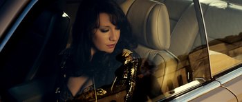 Movie still from “The Devil's Double” (2011), directed by Lee Tamahori – A woman sitting in the back seat of a car; Close Up shot, Overhead angle