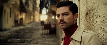 Movie still from “The Devil's Double” (2011), directed by Lee Tamahori – A person wearing a trench coat; Close Up shot, Low angle