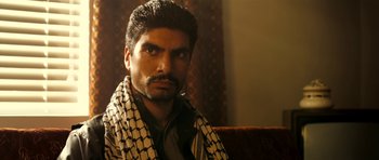 Movie still from “The Devil's Double” (2011), directed by Lee Tamahori – A person with a scarf on; Close Up shot, Low angle