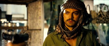 Movie still from “The Devil's Double” (2011), directed by Lee Tamahori – A person wearing a hat; Close Up shot, Over the shoulder angle