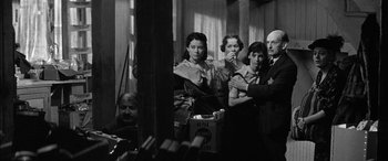 Movie still from “The Diary of Anne Frank” (1959), directed by George Stevens – A black and white photo of a group of people; Medium shot, Low angle