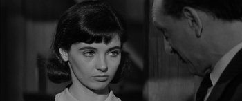 Movie still from “The Diary of Anne Frank” (1959), directed by George Stevens – An old photo of a woman and a man; Close Up shot, Over the shoulder angle