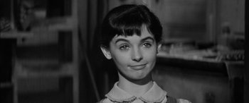Movie still from “The Diary of Anne Frank” (1959), directed by George Stevens – A black - and - white photo of a young woman; Close Up shot, High angle