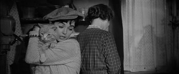 Movie still from “The Diary of Anne Frank” (1959), directed by George Stevens – A woman holding a baby in her arms while standing next to another woman; Close Up shot, Over the shoulder angle