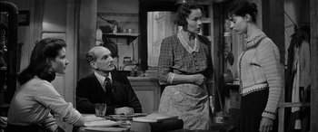 Movie still from “The Diary of Anne Frank” (1959), directed by George Stevens – An older man and a young woman in an old time kitchen; Medium shot, Low angle