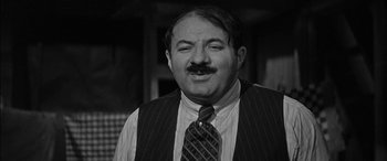 Movie still from “The Diary of Anne Frank” (1959), directed by George Stevens – An older man wearing a tie and a mustache; Close Up shot, Low angle