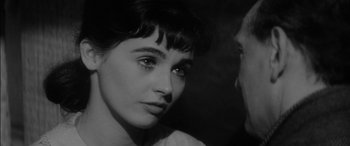 Movie still from “The Diary of Anne Frank” (1959), directed by George Stevens – A black - and - white photo of a woman looking at the camera; Close Up shot, High angle