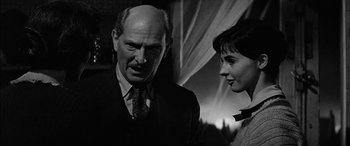 Movie still from “The Diary of Anne Frank” (1959), directed by George Stevens – An older man and a young woman standing next to each other; Close Up shot, Low angle