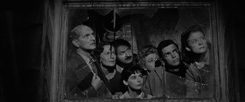 Movie still from “The Diary of Anne Frank” (1959), directed by George Stevens – A black and white photo of a group of people; Medium shot, High angle
