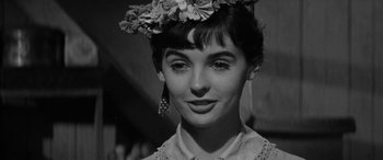 Movie still from “The Diary of Anne Frank” (1959), directed by George Stevens – A black and white photo of a woman wearing a flower crown; Close Up shot, Low angle
