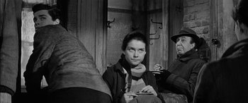 Movie still from “The Diary of Anne Frank” (1959), directed by George Stevens – Black and white photograph of a woman sitting on a bench; Medium shot, Over the shoulder angle
