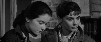 Movie still from “The Diary of Anne Frank” (1959), directed by George Stevens – Two women sitting next to each other in front of a brick wall; Close Up shot, High angle