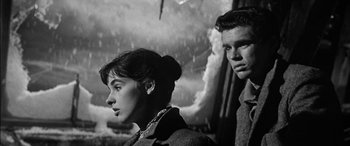 Movie still from “The Diary of Anne Frank” (1959), directed by George Stevens – A man and a woman standing next to each other; Close Up shot, Low angle