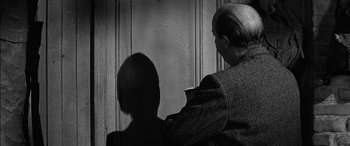 Movie still from “The Diary of Anne Frank” (1959), directed by George Stevens – An older man sitting in front of a woman; Close Up shot, Over the shoulder angle