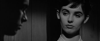 Movie still from “The Diary of Anne Frank” (1959), directed by George Stevens – A black - and - white photo of a woman with short hair; Close Up shot, Low angle