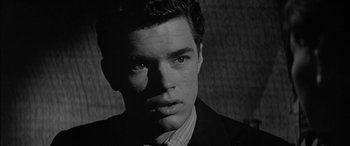 Movie still from “The Diary of Anne Frank” (1959), directed by George Stevens – Black and white photograph of a man in a suit and tie; Close Up shot, Over the shoulder angle