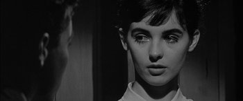 Movie still from “The Diary of Anne Frank” (1959), directed by George Stevens – A black - and - white photo of a woman's face; Close Up shot, Over the shoulder angle