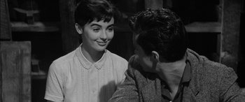 Movie still from “The Diary of Anne Frank” (1959), directed by George Stevens – An old black and white photo of a man and a woman; Close Up shot, Over the shoulder angle