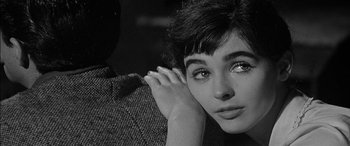 Movie still from “The Diary of Anne Frank” (1959), directed by George Stevens – Black and white photograph of a young woman with her hand on her face; Close Up shot, High angle