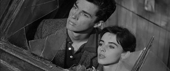 Movie still from “The Diary of Anne Frank” (1959), directed by George Stevens – A man and a woman standing next to each other; Close Up shot, Low angle