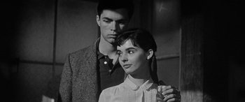 Movie still from “The Diary of Anne Frank” (1959), directed by George Stevens – A man and a woman standing next to each other; Close Up shot, Low angle