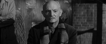Movie still from “The Diary of Anne Frank” (1959), directed by George Stevens – An older man wearing a scarf and a jacket; Close Up shot, Low angle
