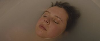 Movie still from “The Diary of a Teenage Girl” (2015), directed by Marielle Heller – A woman is laying down in a bath tub; Close Up shot, Overhead angle