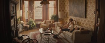 Movie still from “The Diary of a Teenage Girl” (2015), directed by Marielle Heller – Two people sitting on a couch in a living room; Wide shot, High angle