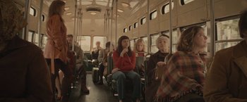 Movie still from “The Diary of a Teenage Girl” (2015), directed by Marielle Heller – A group of people riding on a bus; Wide shot, High angle