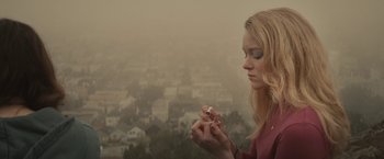 Movie still from “The Diary of a Teenage Girl” (2015), directed by Marielle Heller – A woman is holding a cigarette in her hand; Close Up shot, High angle