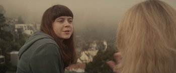 Movie still from “The Diary of a Teenage Girl” (2015), directed by Marielle Heller – A woman with bangs talking to another woman; Close Up shot, Over the shoulder angle