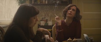 Movie still from “The Diary of a Teenage Girl” (2015), directed by Marielle Heller – Two women sitting at a table with a cigarette in their mouth; Medium shot, Over the shoulder angle