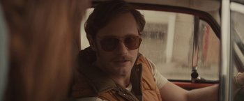 Movie still from “The Diary of a Teenage Girl” (2015), directed by Marielle Heller – A man wearing sunglasses and a vest; Close Up shot, Over the shoulder angle