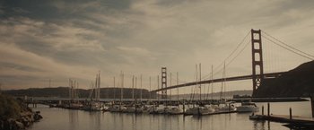 Movie still from “The Diary of a Teenage Girl” (2015), directed by Marielle Heller – A group of boats in the water with a bridge in the background; Extreme Wide shot, Low angle