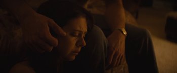 Movie still from “The Diary of a Teenage Girl” (2015), directed by Marielle Heller – A woman sitting on the ground with her eyes closed; Close Up shot, High angle