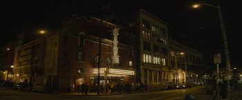 Movie still from “The Diary of a Teenage Girl” (2015), directed by Marielle Heller – A group of people standing on the side of a building; Extreme Wide shot, High angle