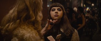 Movie still from “The Diary of a Teenage Girl” (2015), directed by Marielle Heller – A woman putting makeup on her face in front of a mirror; Close Up shot, Over the shoulder angle
