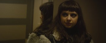 Movie still from “The Diary of a Teenage Girl” (2015), directed by Marielle Heller – A woman is looking into a mirror while wearing a black jacket; Close Up shot, Over the shoulder angle