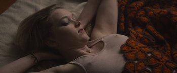 Movie still from “The Diary of a Teenage Girl” (2015), directed by Marielle Heller – A woman laying on a bed with her eyes closed; Close Up shot, High angle