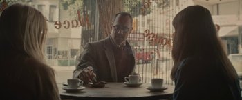 Movie still from “The Diary of a Teenage Girl” (2015), directed by Marielle Heller – A man sitting at a table with two cups of coffee; Medium shot, Over the shoulder angle