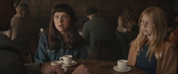 Movie still from “The Diary of a Teenage Girl” (2015), directed by Marielle Heller – A woman sitting at a table with two cups of coffee; Close Up shot, Over the shoulder angle