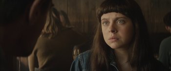 Movie still from “The Diary of a Teenage Girl” (2015), directed by Marielle Heller – A woman with long brown hair and a blue shirt looking to her left; Close Up shot, Over the shoulder angle