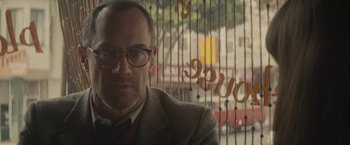 Movie still from “The Diary of a Teenage Girl” (2015), directed by Marielle Heller – A man in a suit sitting in front of a window; Close Up shot, Low angle