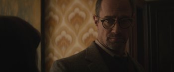 Movie still from “The Diary of a Teenage Girl” (2015), directed by Marielle Heller – A person wearing glasses and a suit; Close Up shot, Low angle