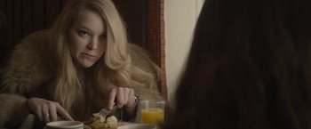 Movie still from “The Diary of a Teenage Girl” (2015), directed by Marielle Heller – A woman sitting in front of a plate of food with orange juice; Close Up shot, Over the shoulder angle